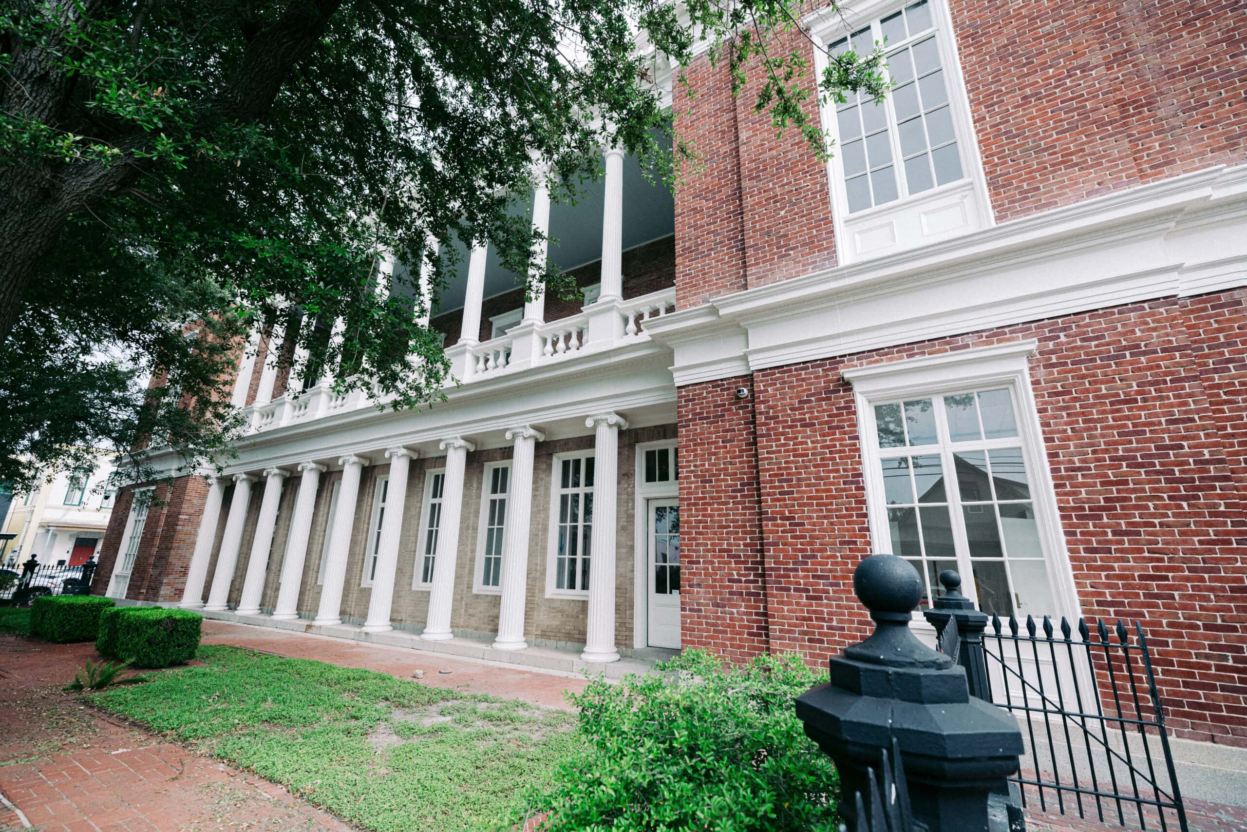 A historic building with white columns, the 1861 Customhouse stands as a classic example of a custom house’s grand architecture. - McNatt Contracting